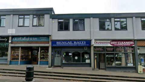 Google maps street view of Bengal Balti and the neighbouring shops. The storefront is royal blue.