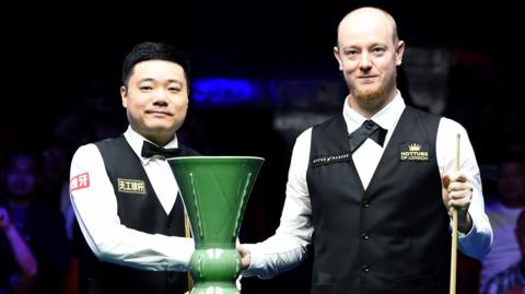 Ding Junhui and Chris Wakelin shake hands before the final of the International Championship