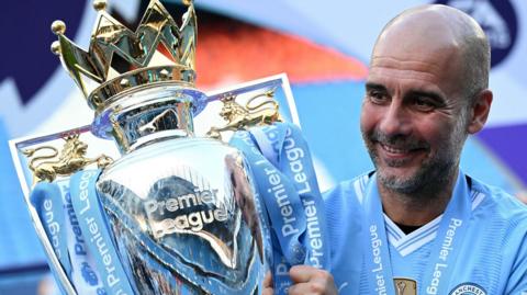Pep Guardiola holds the Premier League trophy