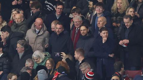 Nicky Butt, Paul Scholes and Sir Alex Ferguson seated together for the Manchester derby at Old Trafford. 