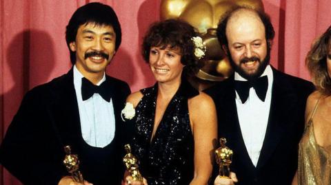 Marcia Lucas and her fellow Oscar winners Richard Chew and Paul Hirsch holding their golden trophies at the 1978 Academy Awards