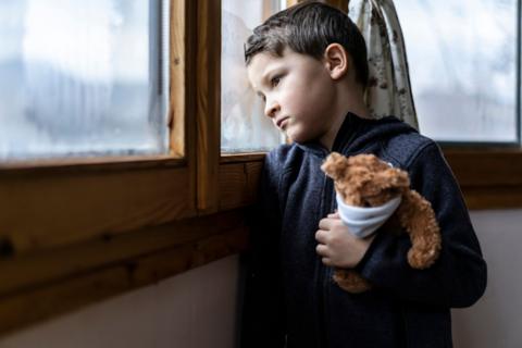 Child holding teddy (stock image)