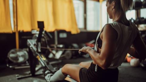 Woman training on rowing machine