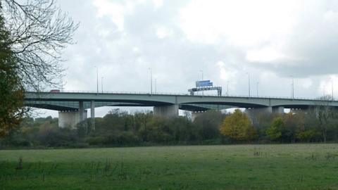 Thelwall viaduct with grass underneath it