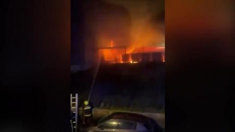 Flames at the football stadium at night.