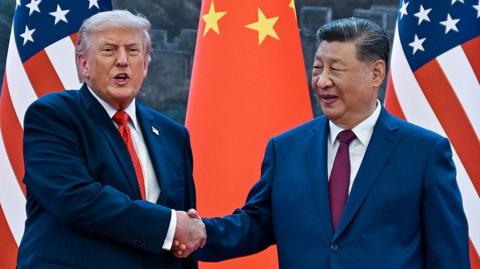 US President Donald Trump (R) shakes hands with China's President Xi Jinping at the Great Hall of the People in Beijing on 14 May, 2026. 