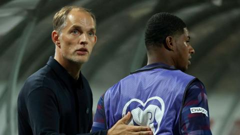 Thomas Tuchel patting Marcus Rashford on his back