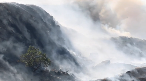 White smoke billows from moorland