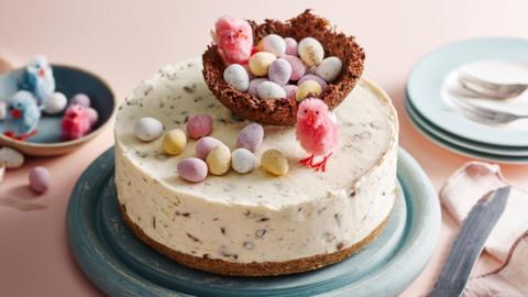 A white cake topped with mini eggs