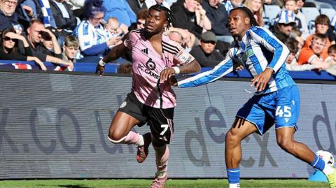 Abdul Fatawu of Leicester City in action with Tayo Adaramola of Sheffield Wednesday during the Sky Bet Championship match between Sheffield Wednesday and Leicester City 