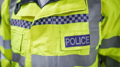 A close-up of a police officer's hi-vis jacket.