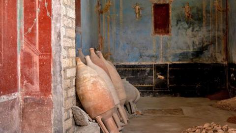 A small room used for prayer looks worn and old but red and blue colours have been preserved