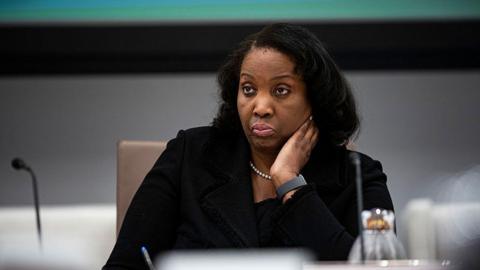 Lisa Cook sitting at a table, wearing black, at a Federal Reserve meeting in June 2025. 