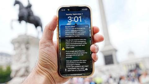 An Emergency Alert is pictured on the screen of a smart phone in central London on September 7, 2025.