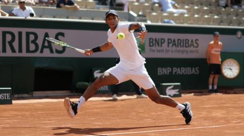 Felix Auger-Aliassime hits a forehand