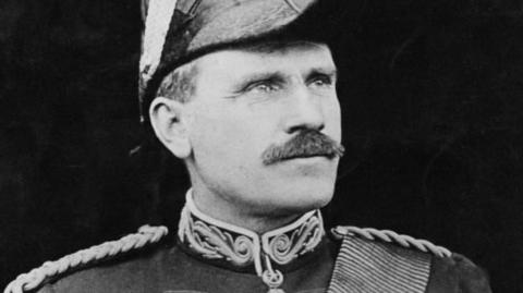 Sir Hector MacDonald is wearing a ceremonial military uniform. He is photographed looking off into the distance.