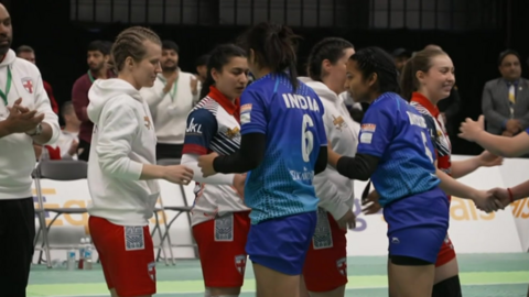 India and England kabaddi players shake hands in a line after the final of the World Cup