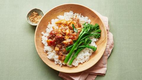 Teriyaki chicken rice bowl on a light green surface