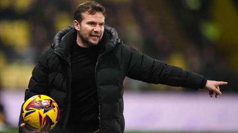 Watford boss Tom Cleverley holding an EFL ball