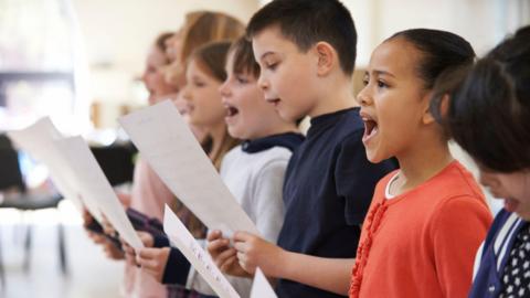a group of kids singing in a choir