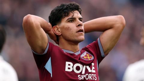 Matheus Fernandes holds his head in his hands