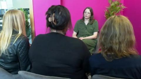 The two women are joined by a third victim and sit with their backs to the cameraman as they are interviewed.