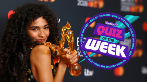 Olivia Dean holding three 2026 Brit Awards