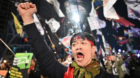 A man shouts slogans as he gestures during a protest against impeached South Korean president Yoon Suk Yeol in Seoul on April 1, 2025. South Korea's Constitutional Court will issue its long-awaited ruling on President Yoon Suk Yeol's impeachment on April 4, months after he was suspended for declaring martial law