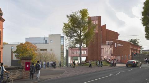 An architect's design illustration of a new teaching centre planned for the university in Derry. It shows a red brick, tall building, and a white brick building linked by a bridge. The buildings are on the side of a road.