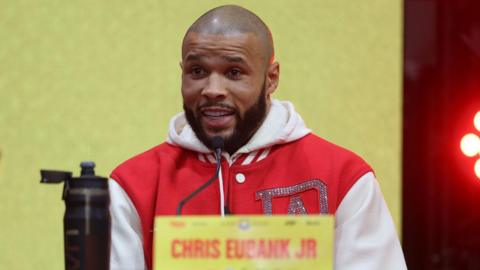 Chris Eubank Jr wearing a red jacket with white sleeves