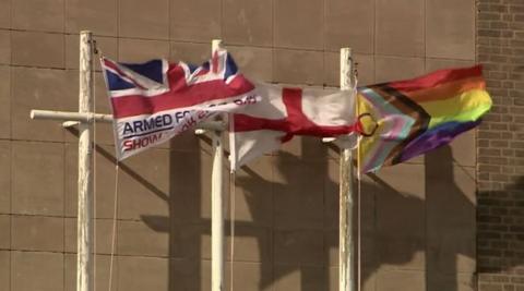 Flags flying outside Shire Hall, with the multi-coloured Progress Pride flag at the centre of the political row pictured on the right hand side. 
