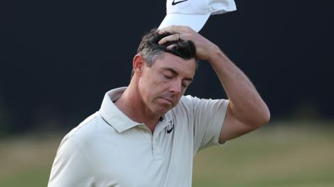 Rory McIlroy cuts a dejected figure as he walks off the 18th green