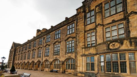 A general view of a Bangor University building, with some seating viewable in the front.