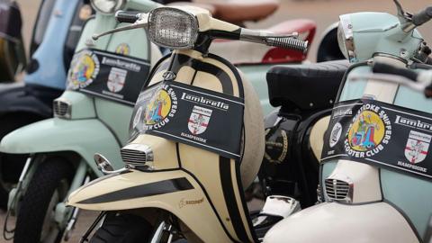 A row of traditional Lambretta scooters