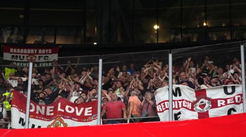 Manchester United fans holding flags at the San Mames Stadium, Bilbao, Spain