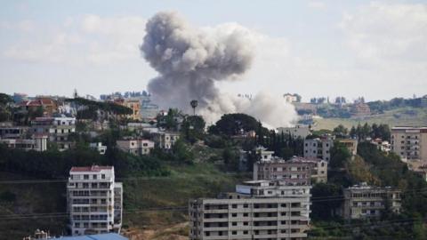 Smoke rising in a semi-built-up area in southern Lebanon following an Israeli strike 