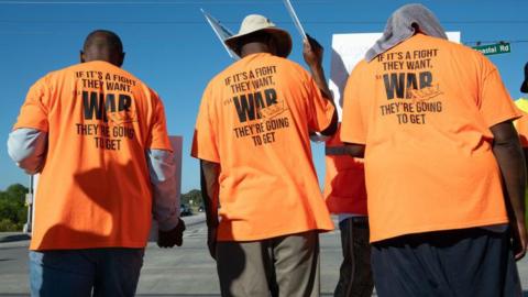 Workers picket outside of the Port of Savannah in Savannah, Georgia on Thursday