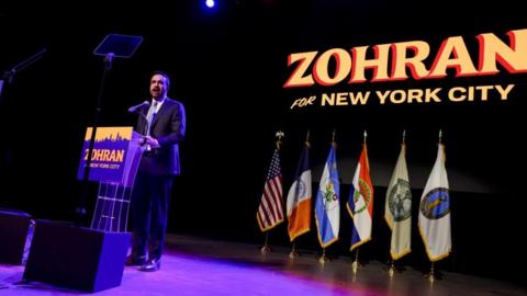 Zohran Mamdani speaks on stage in New York
