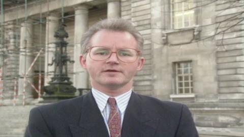 Reporter standing in front of a court 