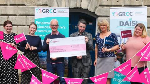 Gloucestershire Rural Community Council receiving the cheque