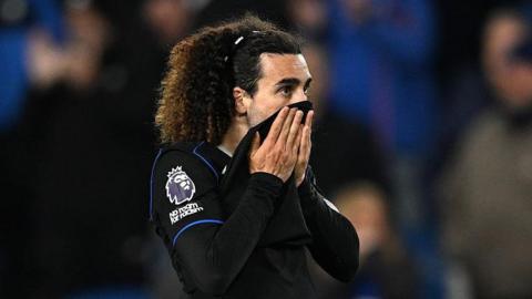 Marc Cucurella pulls his shirt up over his mouth after defeat at Brighton