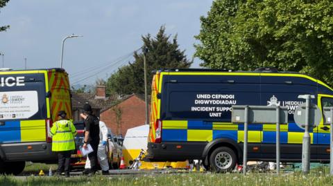 Emergency services staff and vehicles on Aberthaw Road.