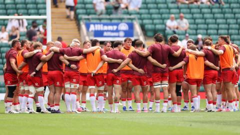 Wales players in a huddle before the game against the Barbarians