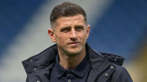 Portsmouth boss John Mousinho looks on 