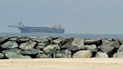  A ship is seen in the Persian Gulf off the coast of Sharjah the day after the failure of US-Iran peace talks on April 13, 2026. 