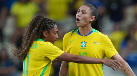 Kerolin tries to calm Brazil team-mate Bia Zaneratto down