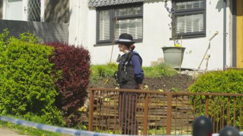 Police officer stands at the cordon near where the body was found on an estate at Trevethin, Pontypool