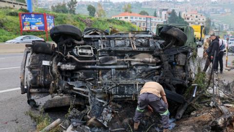 Rescuers work at the site of an Israeli air strike that targeted a vehicle in Jiyeh, south of Beirut, Lebanon (15 April 2026)