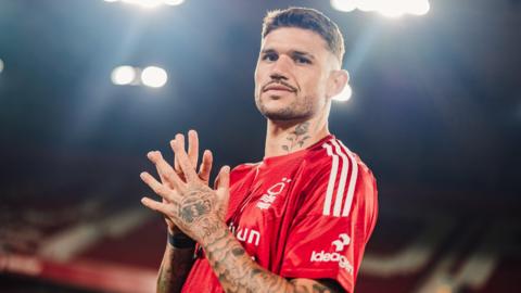 Morato looking at the camera standing in an empty City Ground