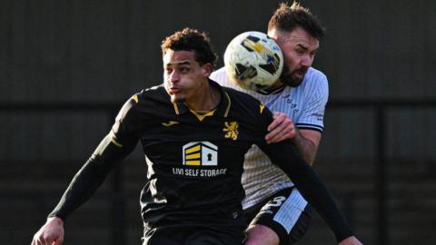 Livingston forward Tete Yengi (left) and Ayr's Scott McMann in action